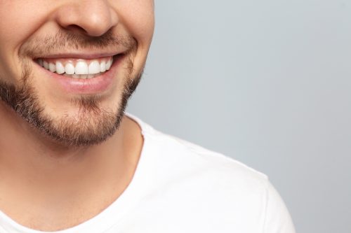 Close of man with goatee in white shirt smiling