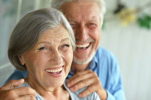 Older couple embracing and laughing together