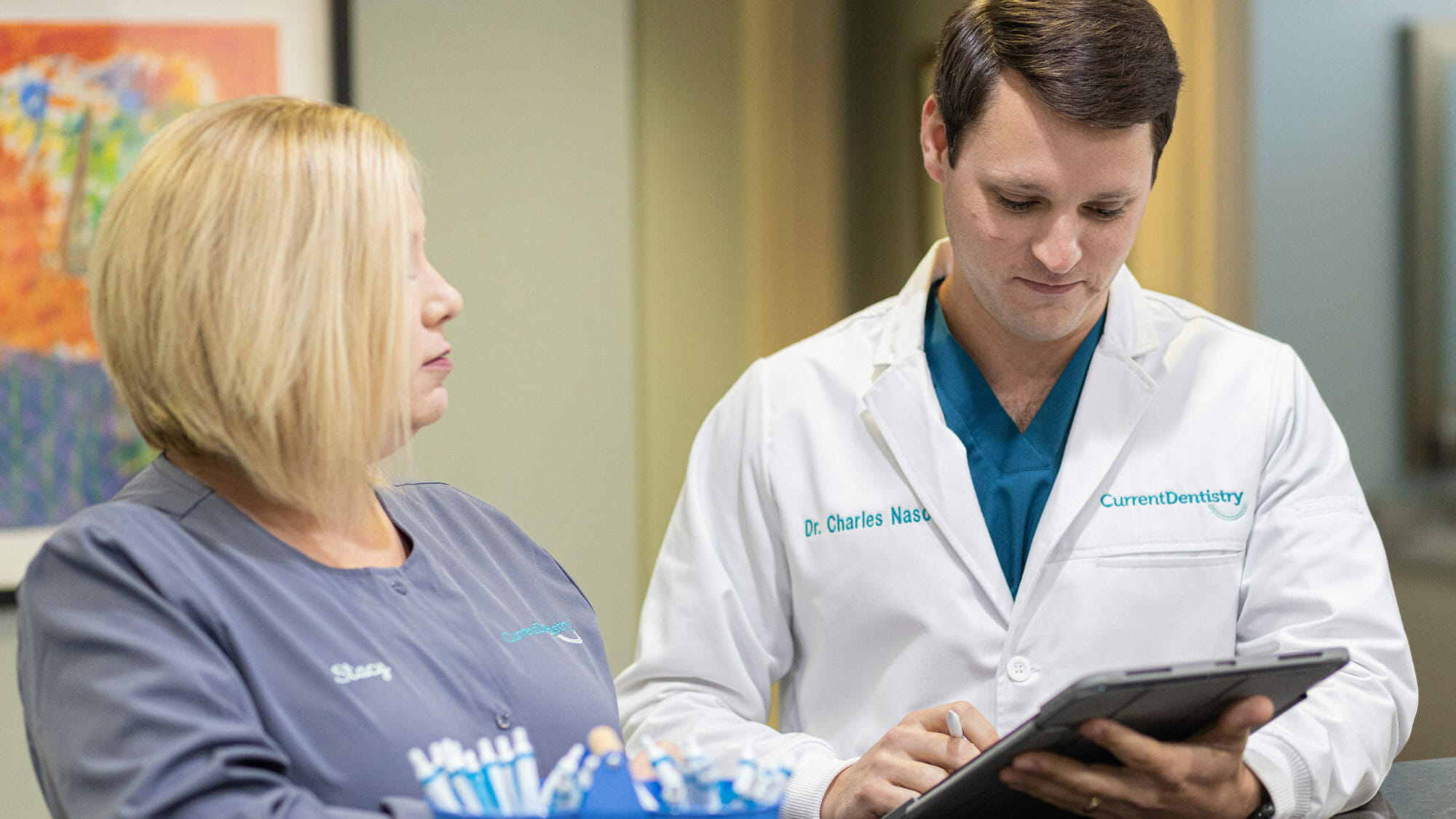 Dentist talking to assistant